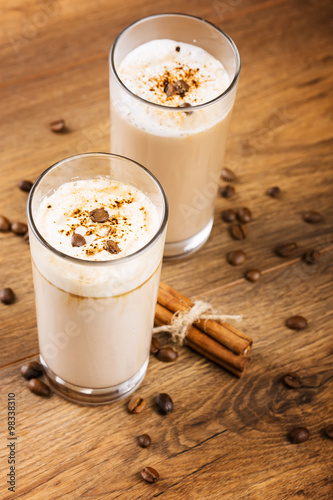 glass of milk and cookie on wooden background
