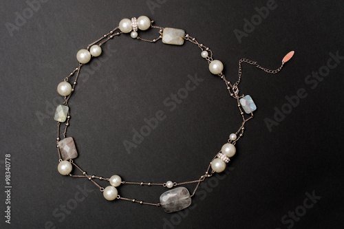 Necklace with pearls and stones on a black background