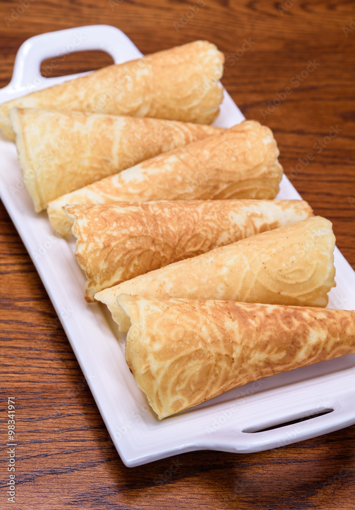 Holiday Krumkake cookies ready to eat on a white serving platter
Holiday Krumkake cookies ready to eat on a white serving platter