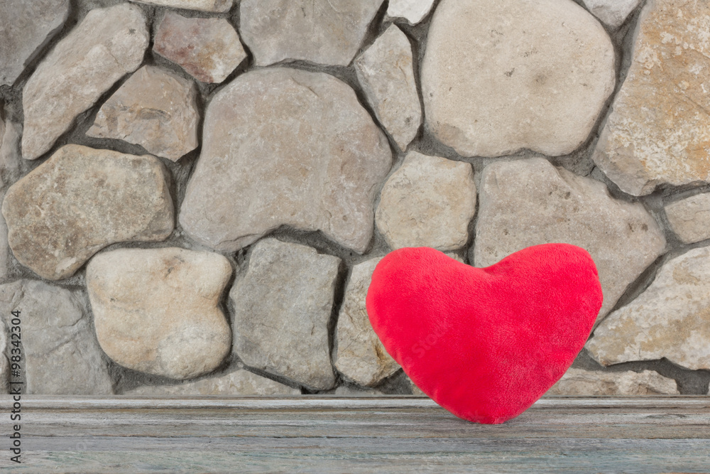 plush red heart on the background of a stone wall, the concept of love and romance. Free space for text. Copy space plush red heart on the background of a stone wall, the concept of love and romance. Free space for text. Copy space