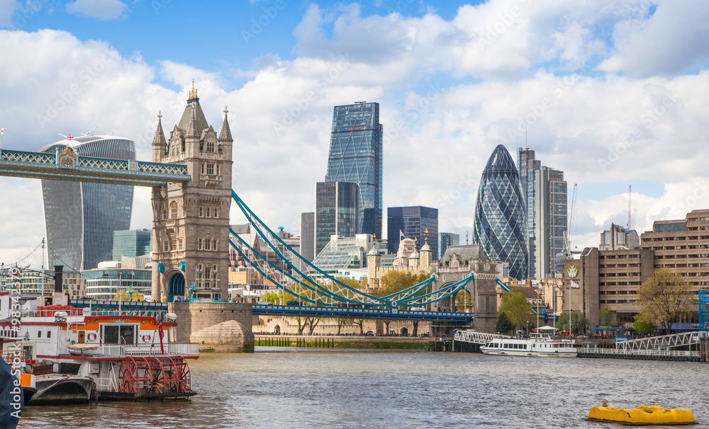 Naklejka premium LONDON, UK - APRIL 30, 2015: Tower bridge and City of London financial aria on the background. View includes Gherkin and other buildings