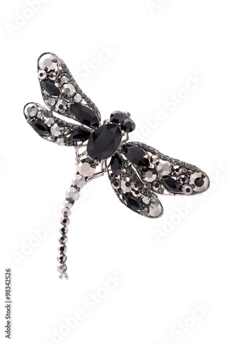 brooch in the form of a black dragonfly on a white background