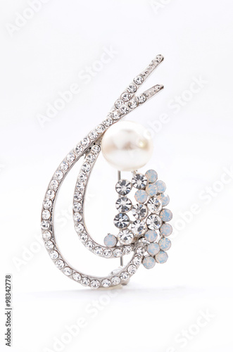 brooch with pearl on a white background