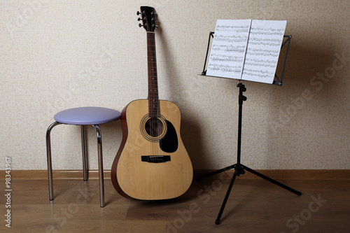 Acoustic guitar propped on ...