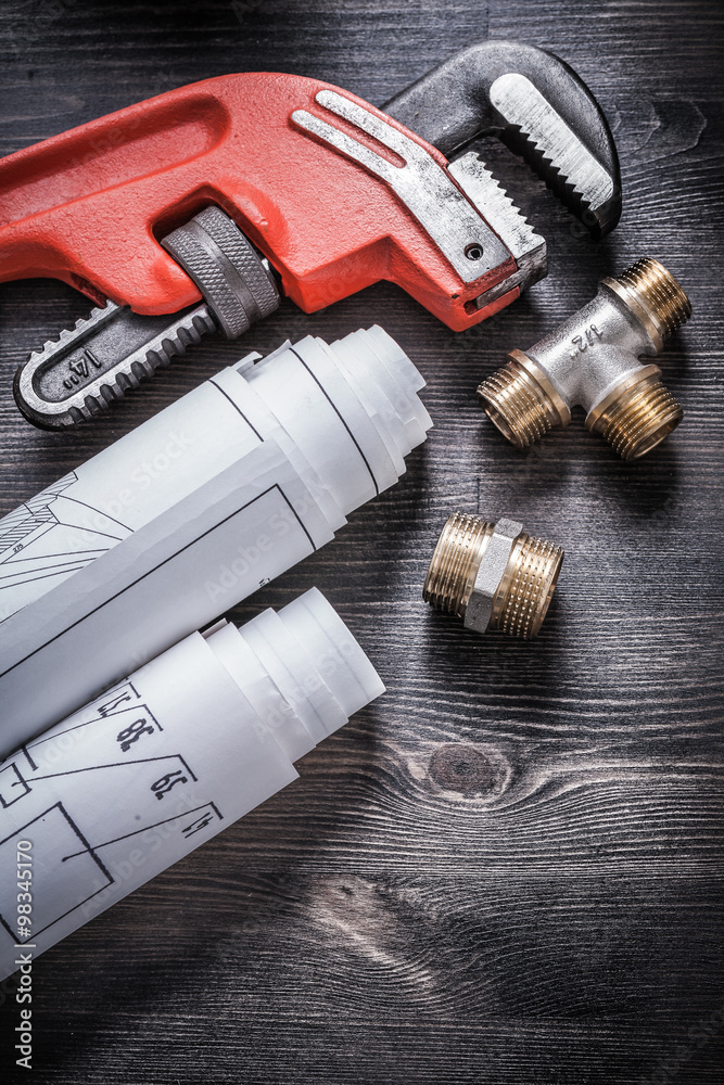 Pipe wrench copper plumbing fixtures rolled up construction plan Pipe wrench copper plumbing fixtures rolled up construction plan