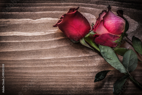 Red roses on wooden board holidays concept