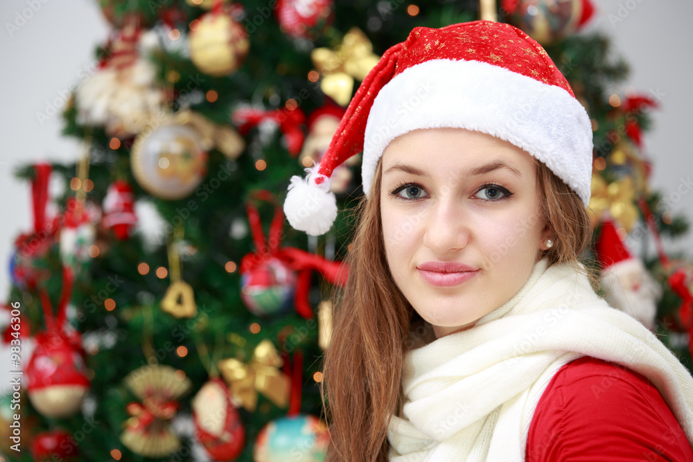 Beautiful girl in front of a Christmas tree
