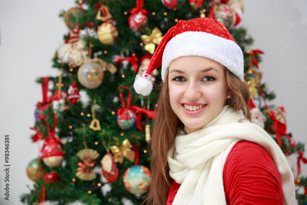 Beautiful girl in front of a Christmas tree