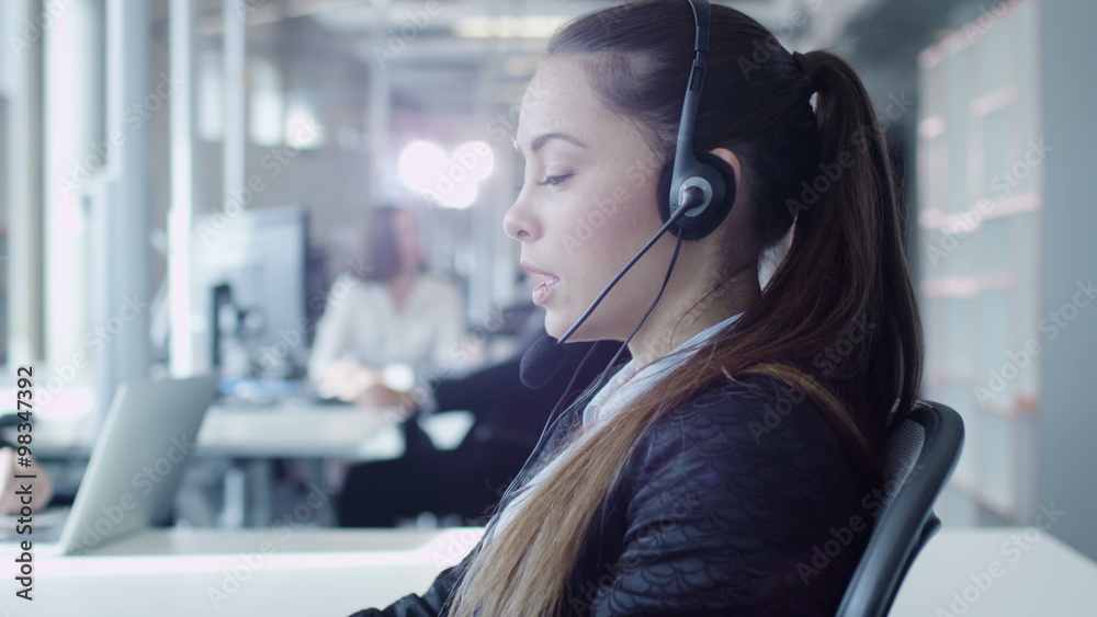 Female Customer Support Worker in Call Center. Shot on RED Cinema Camera