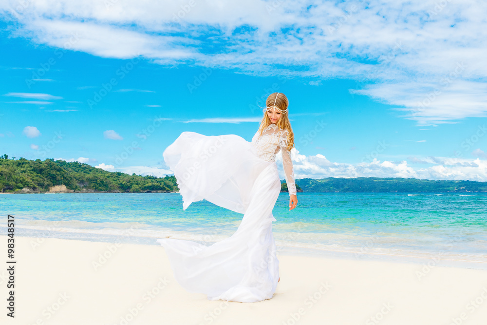 Beautiful blond bride in white wedding dress with big long train Beautiful blond bride in white wedding dress with big long train