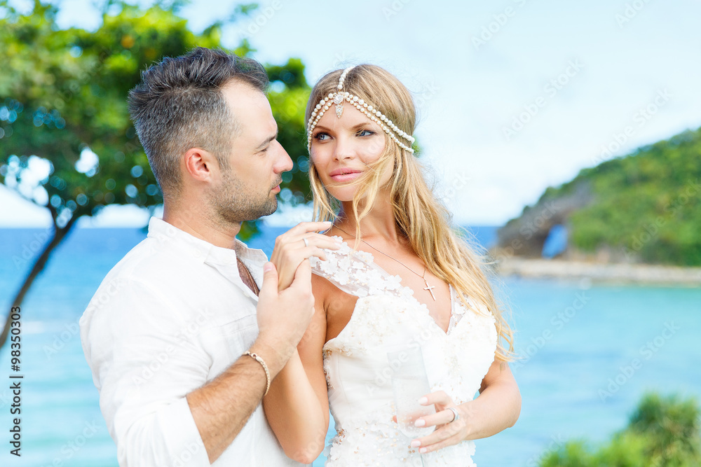 Happy bride and groom having fun on a tropical beach. Wedding an Happy bride and groom having fun on a tropical beach. Wedding an
