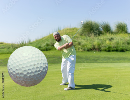Successful man playing golf at club
