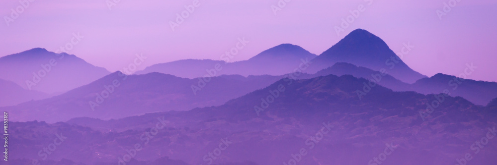 Skyscape of cold purple mountains with mist and fog close to Quetzaltenango - obrazy, fototapety, plakaty 