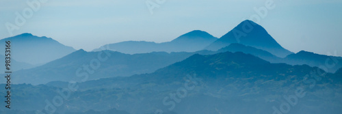 Skyscape of cold blue mountains with mist and fog close to Quetzaltenango