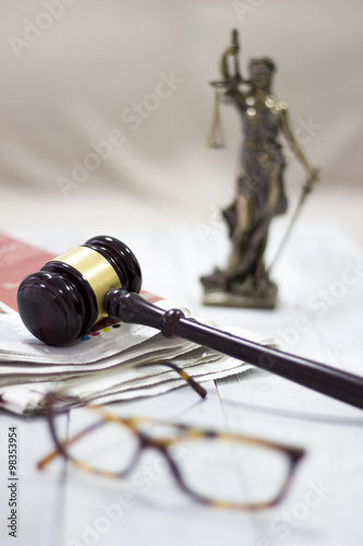 Law concept, statue, gavel, newspaper and glasses