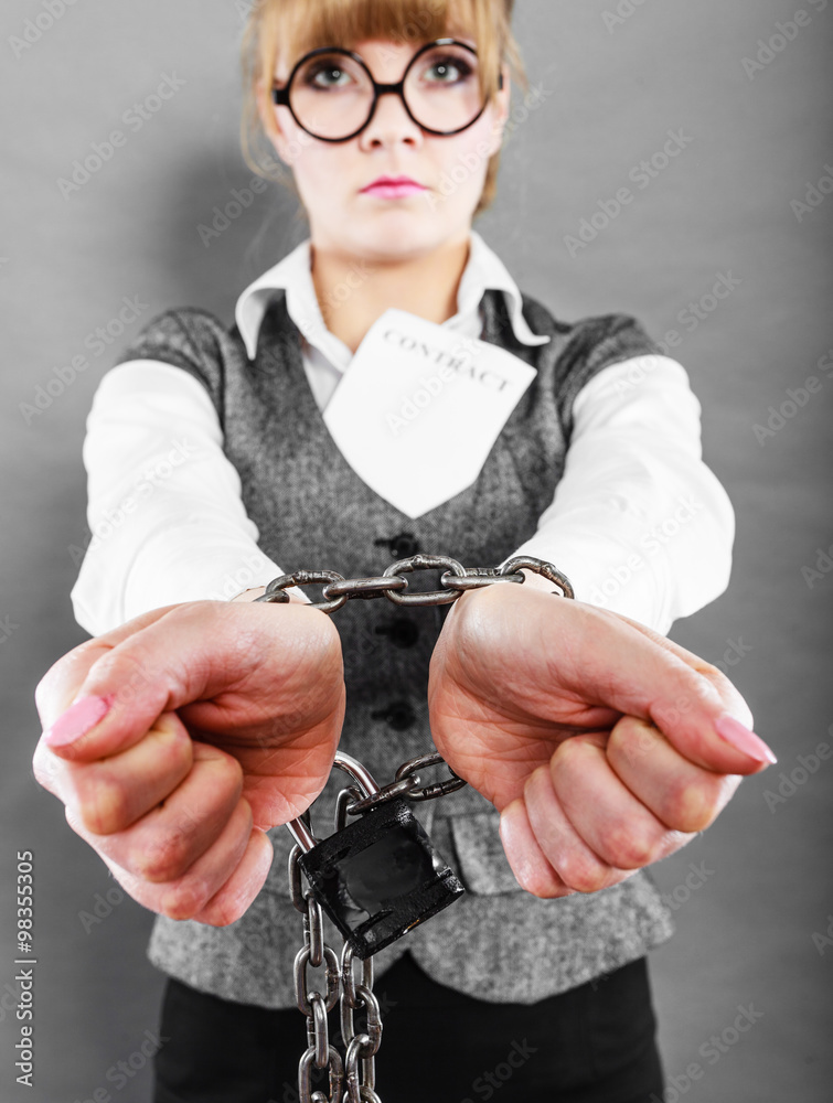 businesswoman with chained hands holding contract