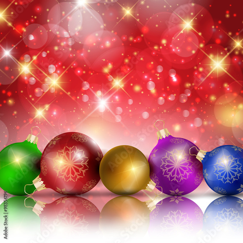 Multi-colored Christmas balls on red sparkling background