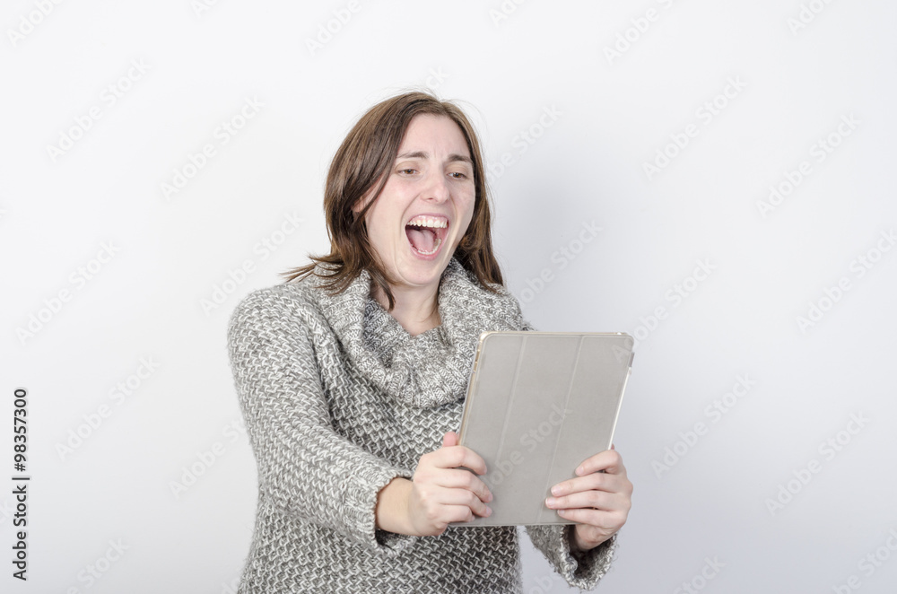 Girl makes a video conference through tablet. very surprise Girl makes a video conference through tablet. very surprise