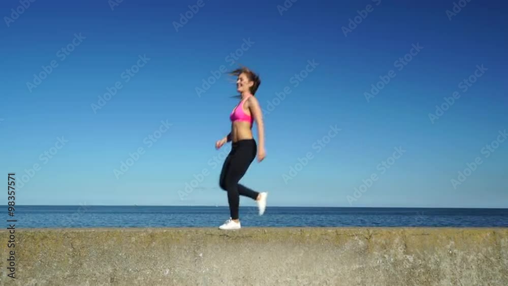 Woman doing sports exercises outdoors by seaside 4K Woman doing sports exercises outdoors by seaside 4K