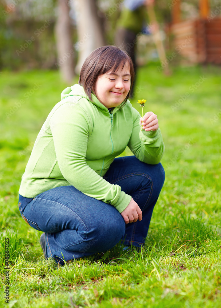 young adult woman with disability enjoying nature in spring garden young adult woman with disability enjoying nature in spring garden