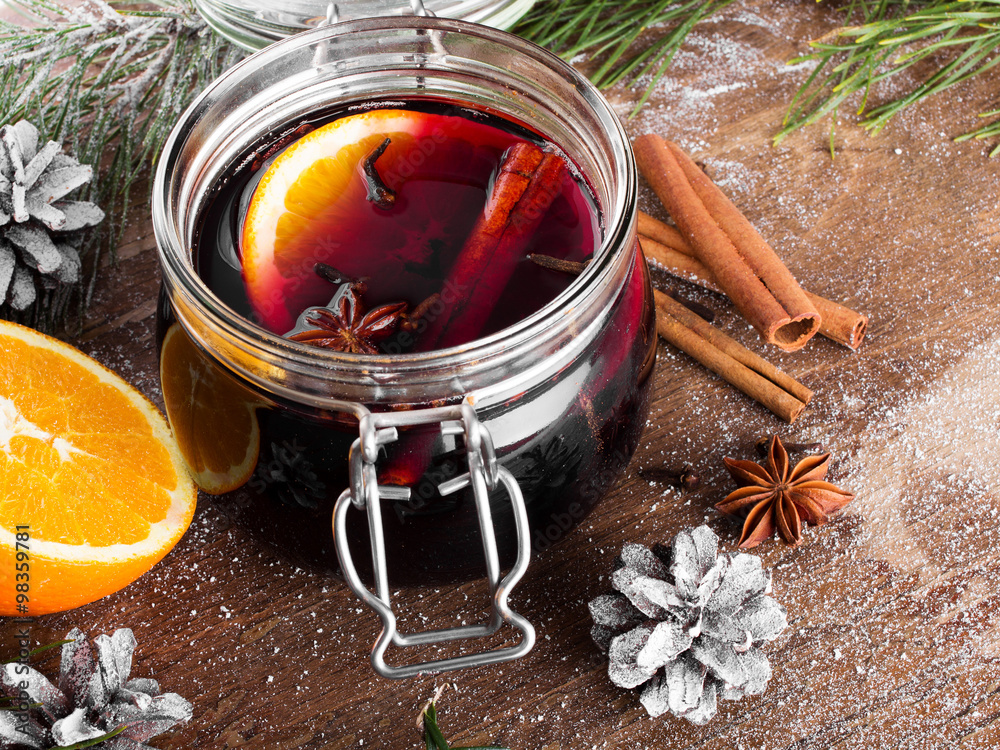 Christmas drink with orange fruit, anise, cinnamon and cloves on wooden table Christmas drink with orange fruit, anise, cinnamon and cloves on wooden table
