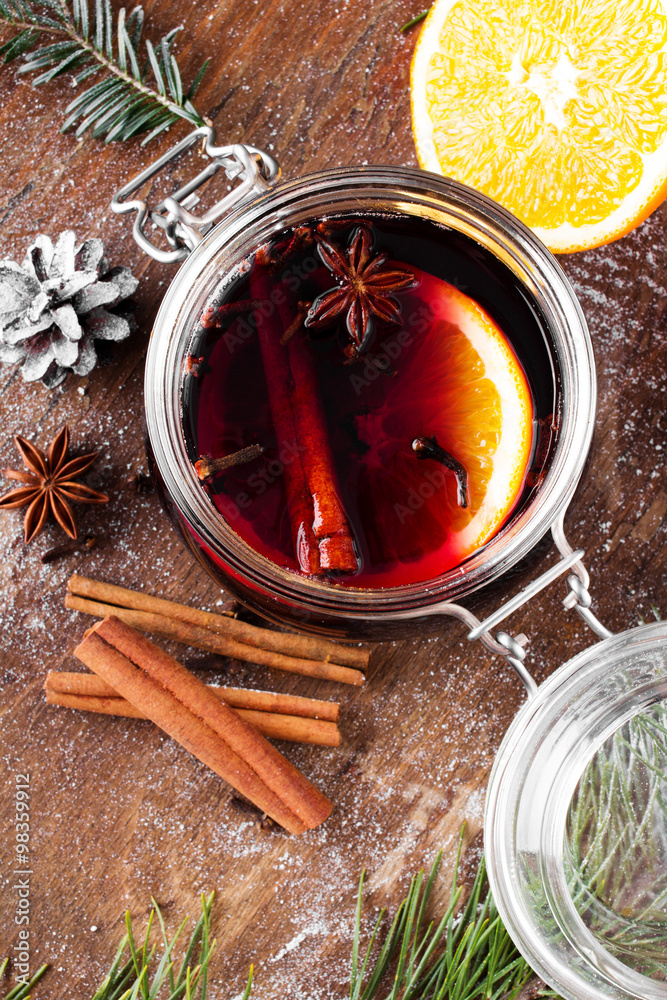 Christmas drink with orange fruit, anise, cinnamon and cloves on wooden table Christmas drink with orange fruit, anise, cinnamon and cloves on wooden table