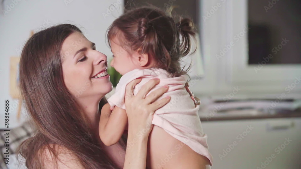Loving mom playing with her little daughter in bedroom Loving mom playing with her little daughter in bedroom