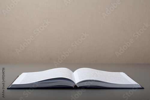 Open book on a gray table closeup