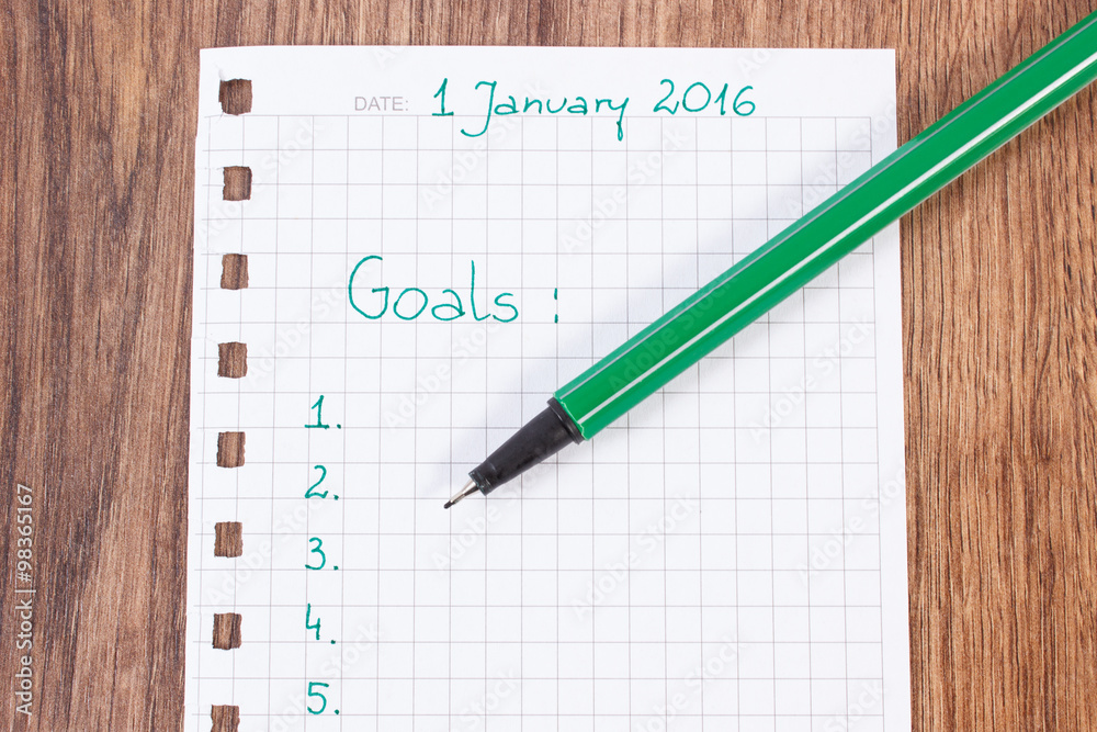 Pen and notebook for planning new years resolutions and goals Pen and notebook for planning new years resolutions and goals