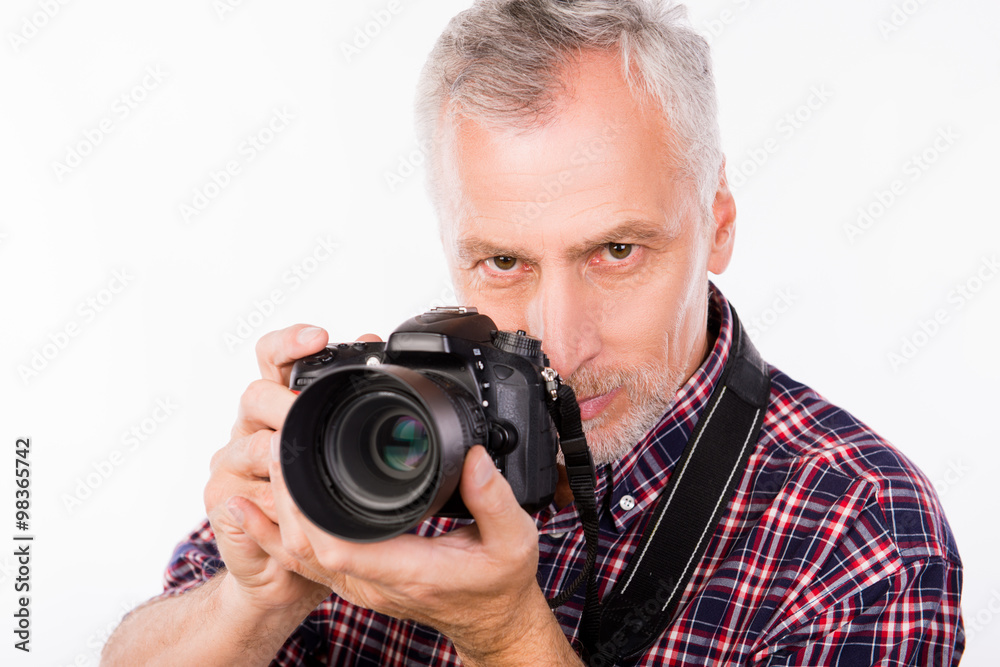 Portrait of senior photographer with camera in her hands Portrait of senior photographer with camera in her hands