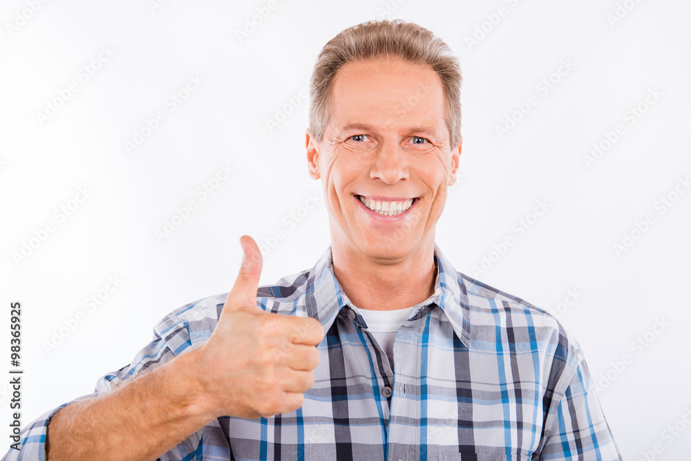 Handsome mature man showing gesture thumb up Handsome mature man showing gesture thumb up
