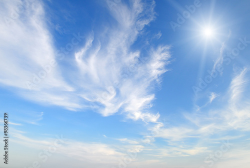 sun on blue sky with white clouds