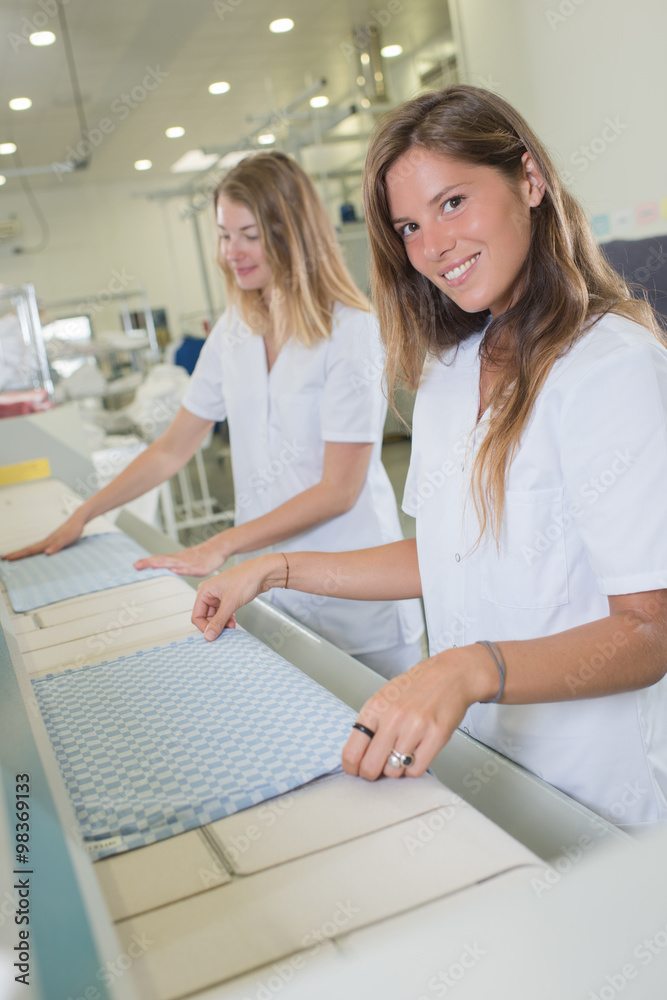 Fototapeta premium women folding fabric