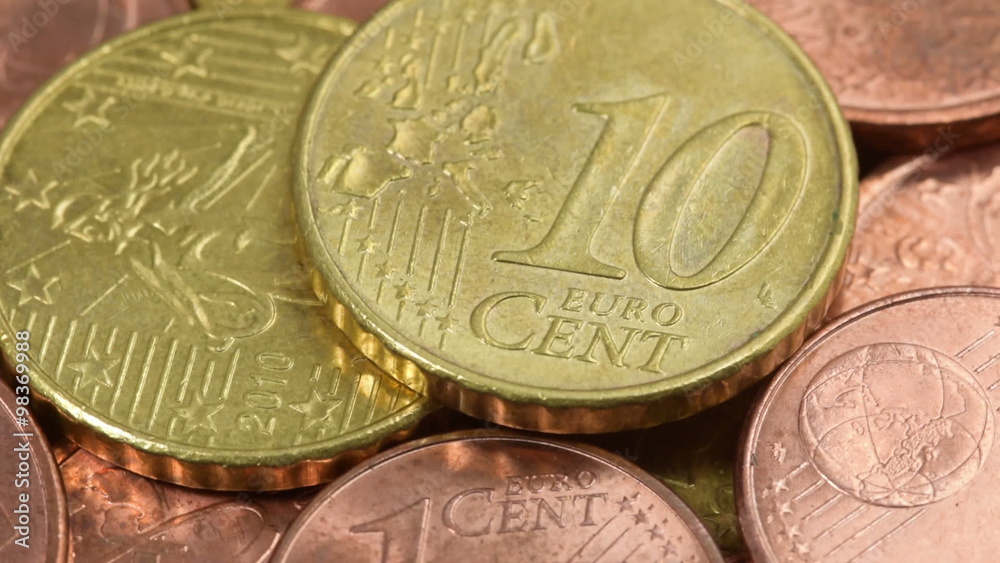 Euro cent coins macro rotating swiftly under the studio lighting Euro cent coins macro rotating swiftly under the studio lighting