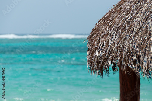 The Native Roof made of leave facing the blue caribbean ocean on Little Corn Island
