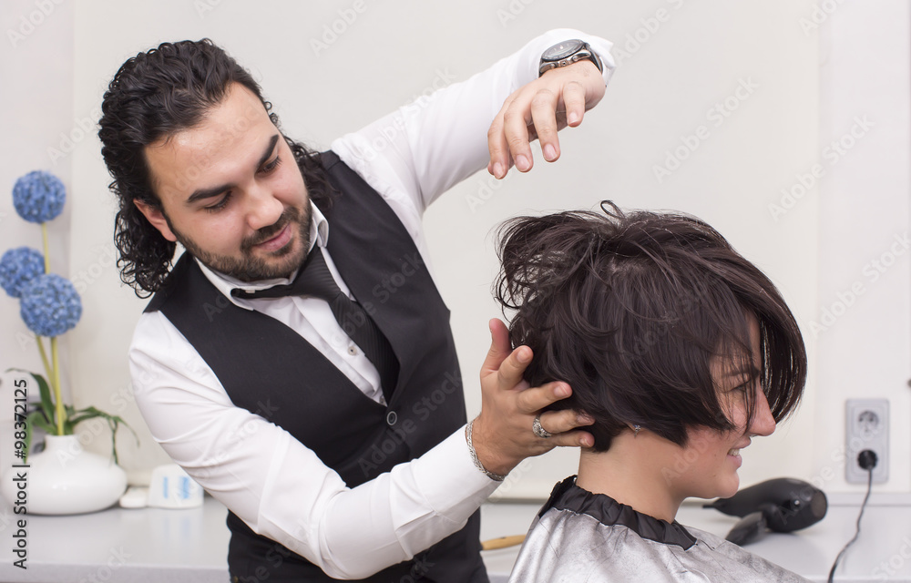 Hairdresser makes hair woman in a beauty salon Hairdresser makes hair woman in a beauty salon