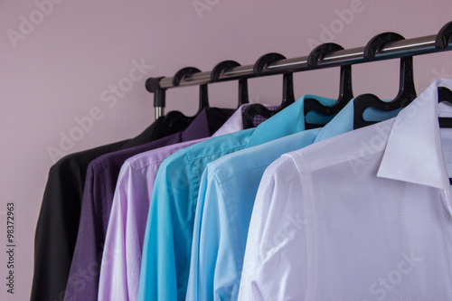 colored men's shirts that hang on hangers