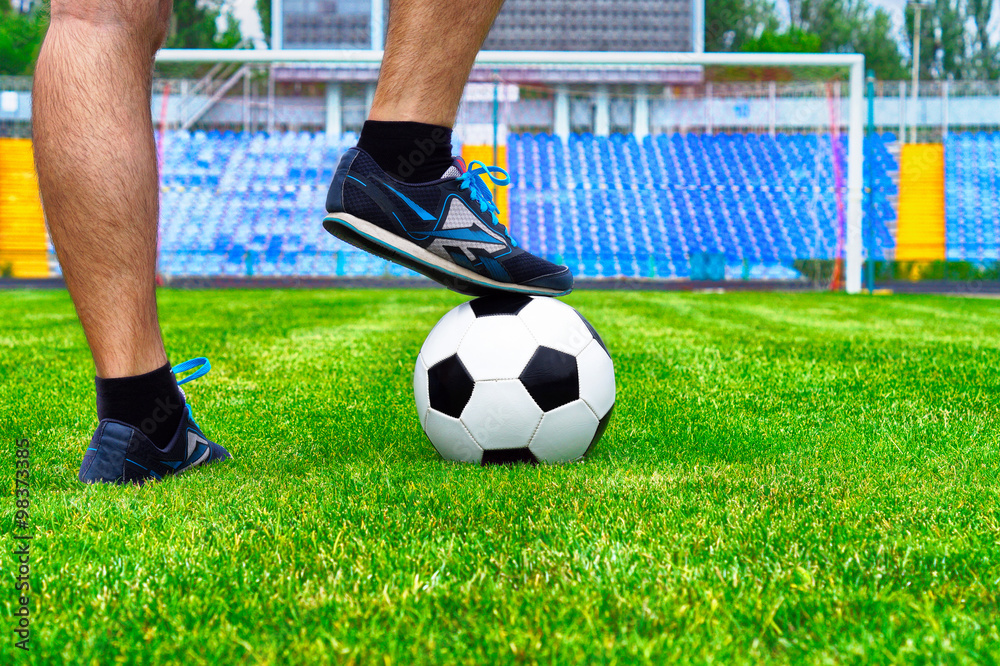 Fototapeta premium man preparing to hit the ball on the green lawn of the stadium