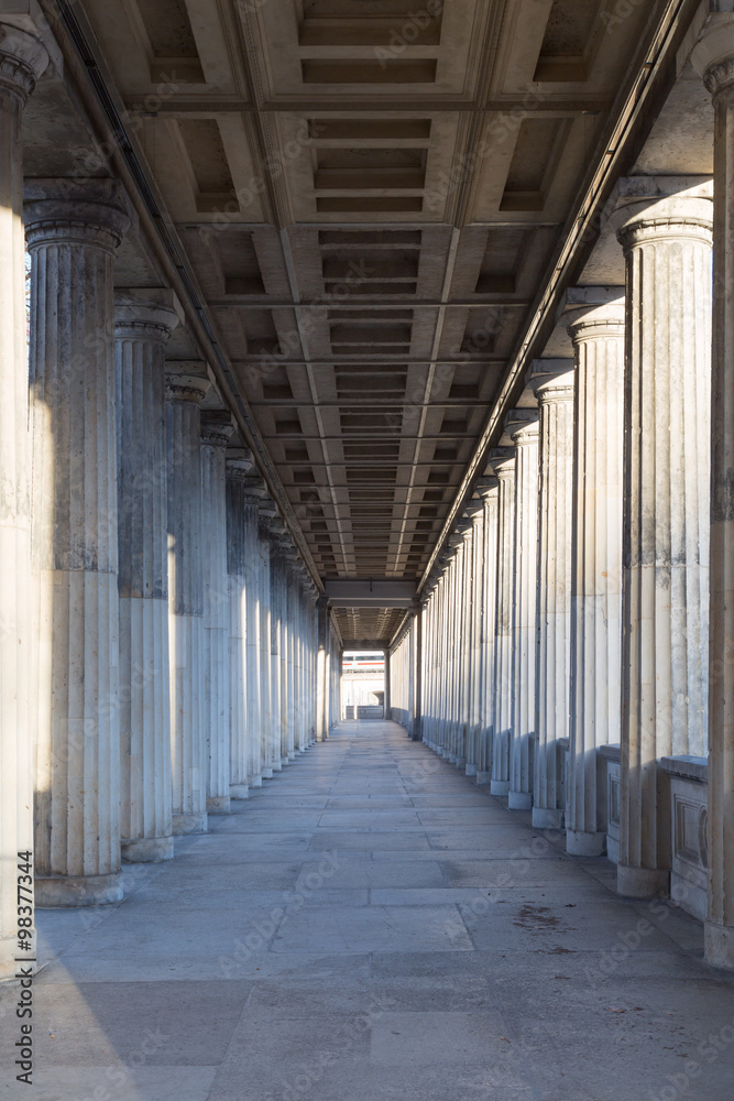 A long corridor between many columns in a historical building in berlin
