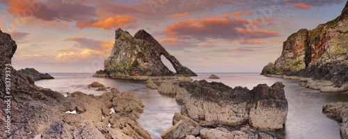 Bow Fiddle Rock, natural arch on Moray coast, Scotland, sunset photo