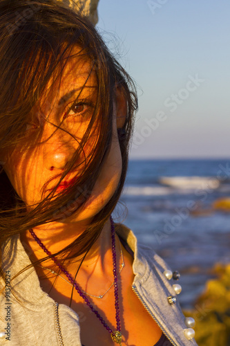Beautiful girl in sunset portraits at sea