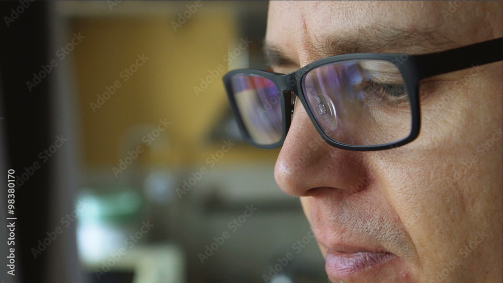 The face of young man with the glasses near a window at home
The face of young man with the glasses near a window at home