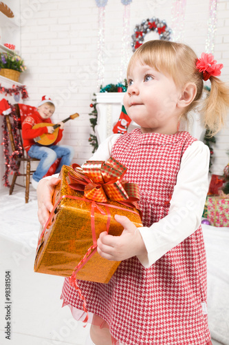 Baby girl beside Christmas tree