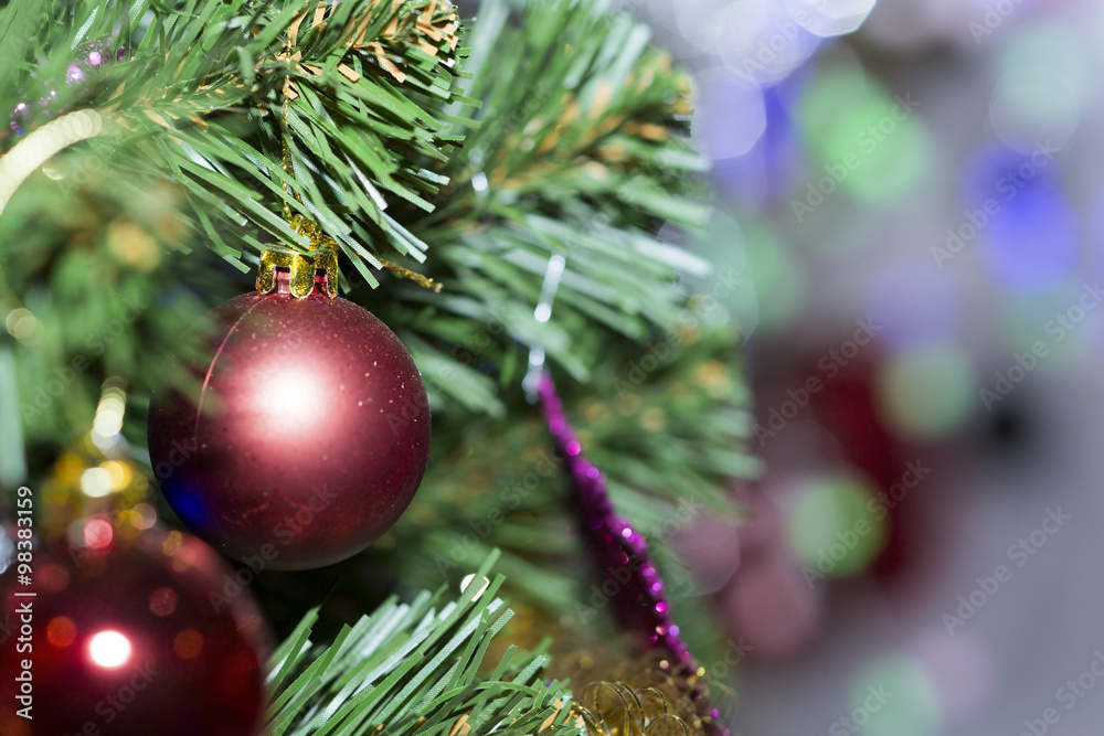 Christmas tree decorated with toys. Ball hanging on a branch of a tree. Christmas tree decorated with toys. Ball hanging on a branch of a tree.