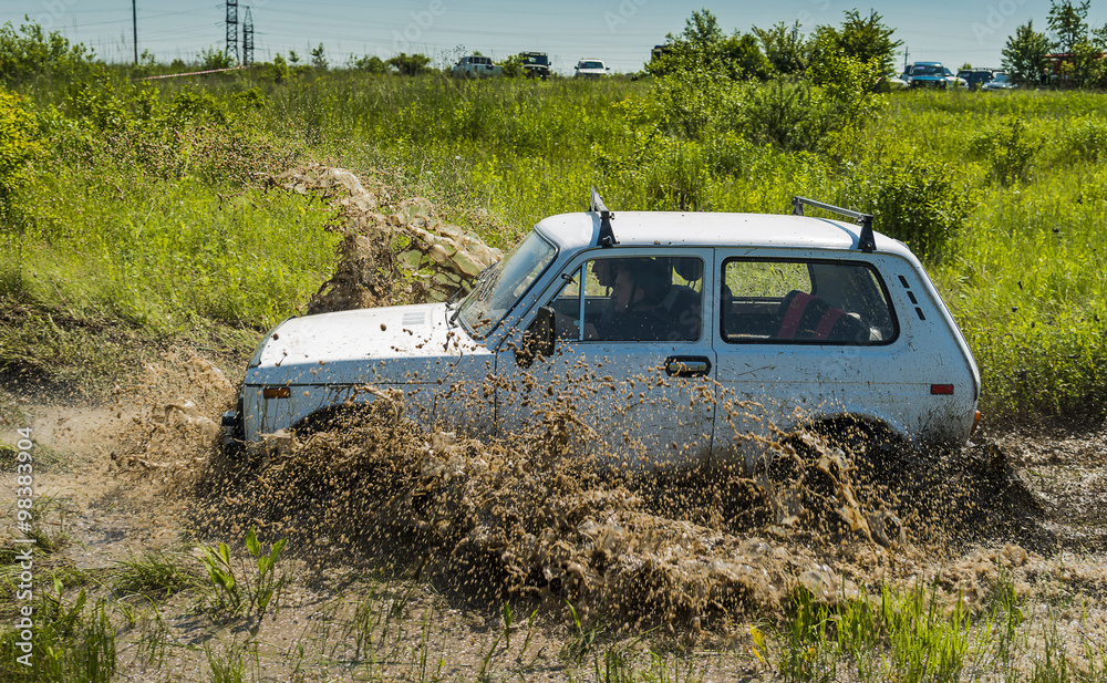 Off-road vehicle brand VAZ-NIVA overcomes a pit of mud Off-road vehicle brand VAZ-NIVA overcomes a pit of mud