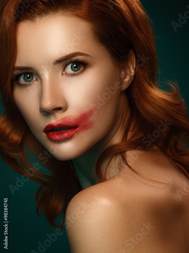 Portrait of young caucasian redhead female, red smeared lips