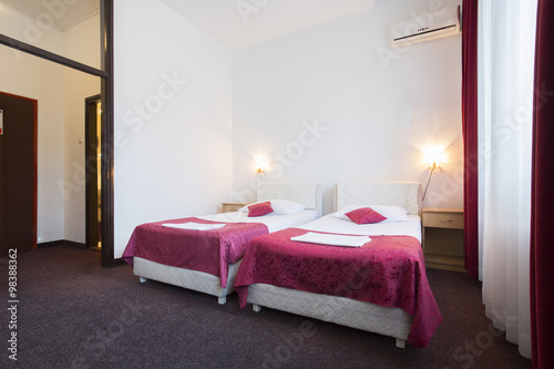 Interior of a hotel room with two beds