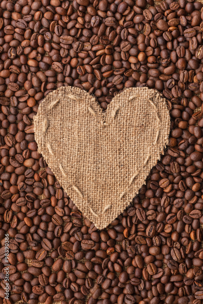 Frame in the shape of heart made of burlap with coffee beans Frame in the shape of heart made of burlap with coffee beans