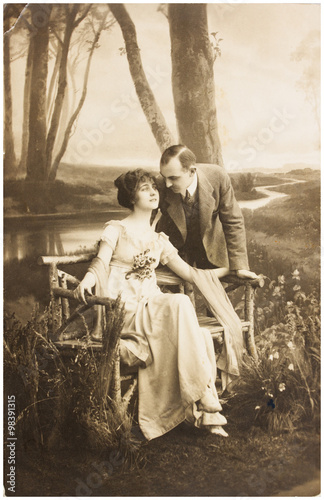 young romantic couple of woman and man in spring garden