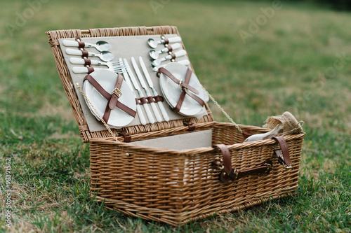 picnic basket full of food and dishes for a perfect picnic in the park
